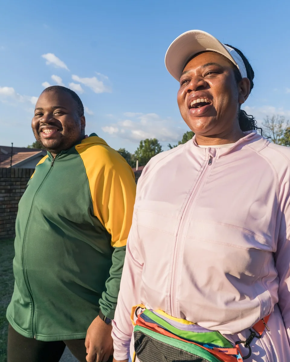Madam O laughing with a fellow walker on a morning walk.