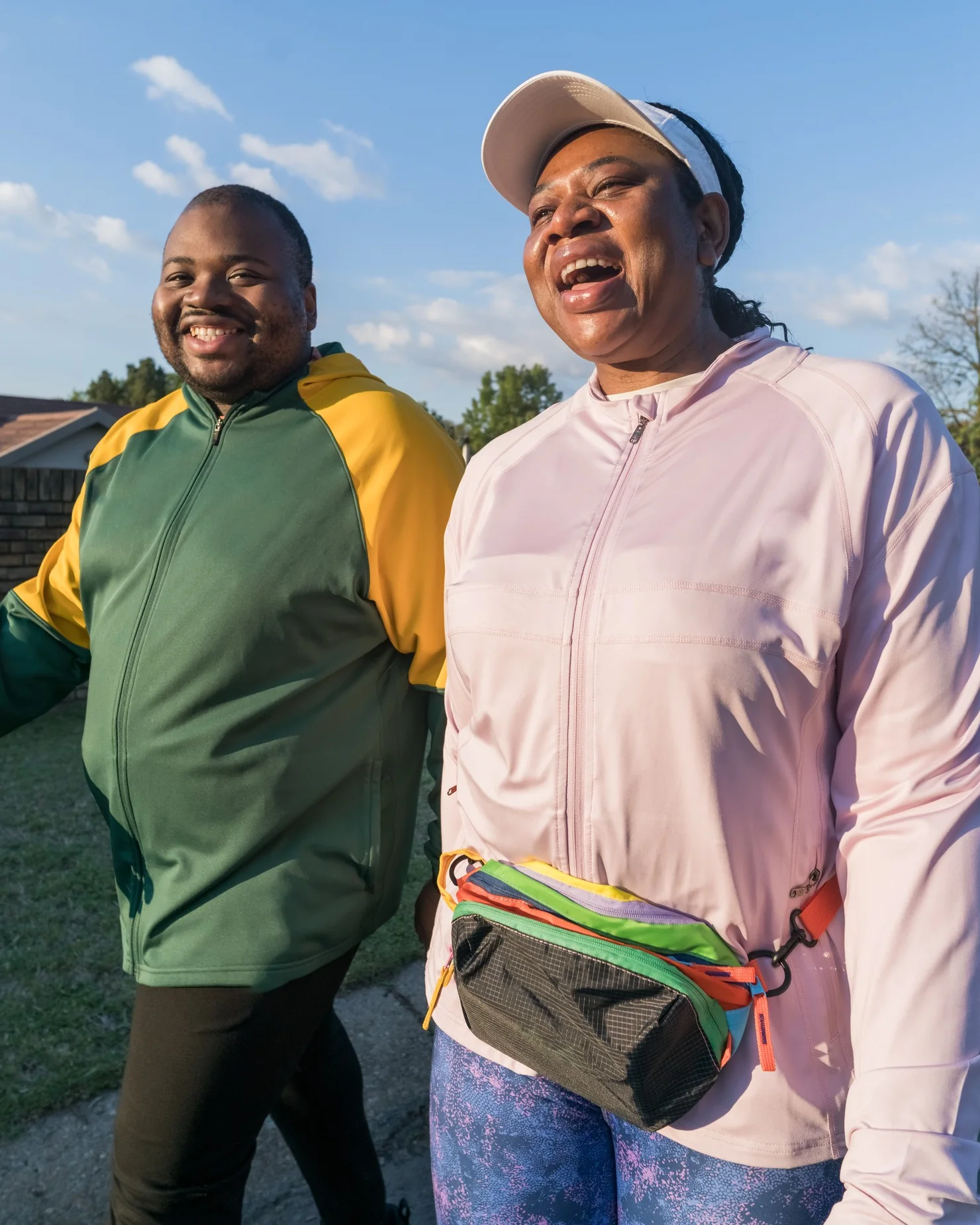 Madam O, Mrs Ornica Mukhavhuli, laughing with a fellow walker on a morning walk.