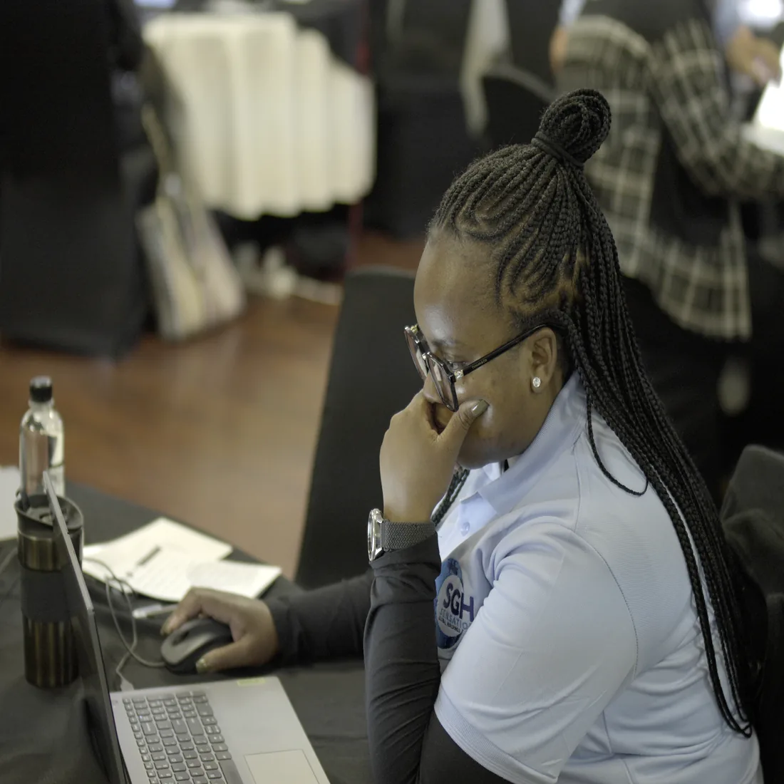 A Sensation Global Holdings staff member working at her laptop.