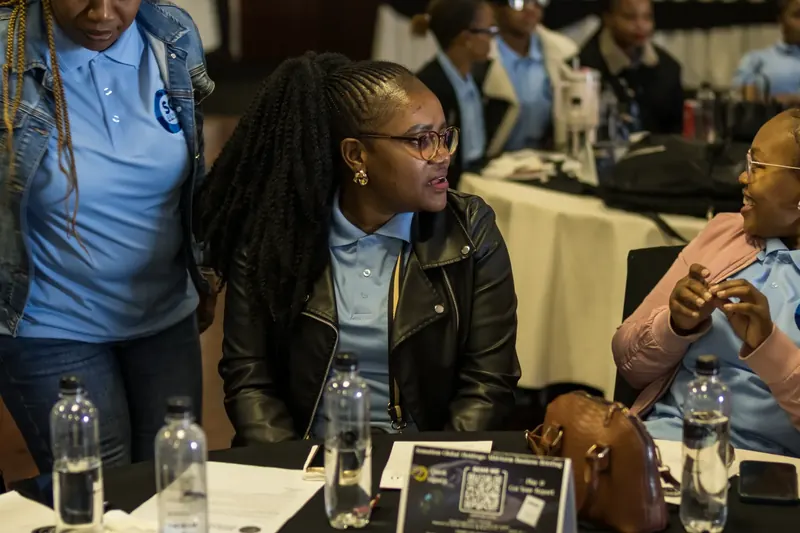 Colleagues talking at a Sensation Global Holdings business briefing.
